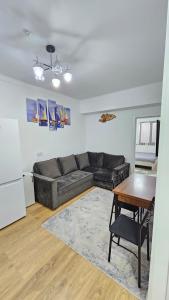 a living room with a couch and a table at Квартира в Радуге in Chon-Sary-Oy