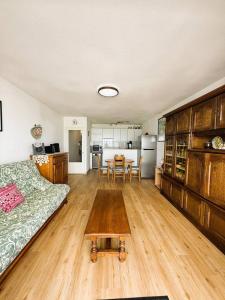 a living room with a couch and a table at Le Clos D'illies in Mers-les-Bains