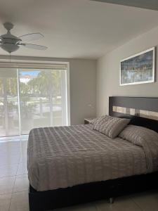 a bedroom with a large bed and a large window at Villa Magna departamento en Nuevo Vallarta in Nuevo Vallarta  +18 photos