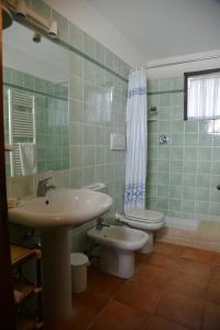 a bathroom with a sink and a toilet at Agriturismo Fattoria Il Casalone in Orbetello +19 photos