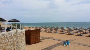 a group of chairs and umbrellas on a beach at Studio near the beach in Albufeira