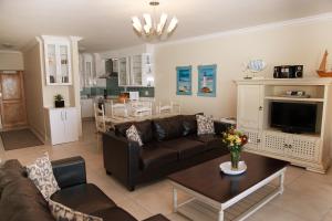 a living room with a couch and a table at Diaz Beach Apartment in Diasstrand