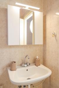 a bathroom with a sink and a mirror at Homely Escape in Chios