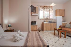 a living room with a bed and a kitchen at Homely Escape in Chios +24 photos