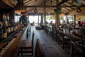 a restaurant with tables and chairs and people sitting at them at 15 Palms Beach Resort in Ko Chang