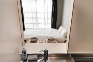 Postel nebo postele na pokoji v ubytování Tabiya Shinamachi - New built APT at Ikebukuro, Relaxing Stay in Central Tokyo