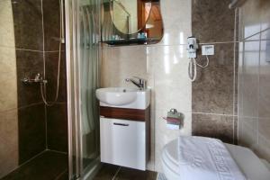 a bathroom with a sink and a shower and a toilet at Theodian Hotel in Istanbul +50 photos