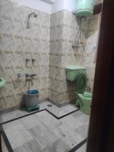 a bathroom with a green toilet and a sink at Hotel Arohi in Vashisht +25 photos