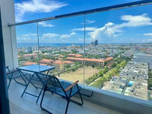 a table and chairs on a balcony with a view at Apec Whydham Tuy Hoa Phu Yen Hotel & Apartment in Tuy Hoa