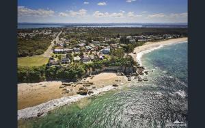 an aerial view of a resort on the beach at Cliff Cottage - Noraville in Norah Head