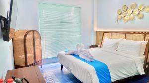 a bedroom with a bed with a towel on it at Grand Malioboro Yogyakarta in Yogyakarta +172 photos