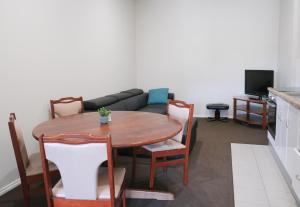 a living room with a table and a couch at Manjimup Gateway Hotel in Manjimup