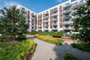 an apartment building with a pathway in front of it at Bemowo Homely Apartment by BookingHost in Warszawa