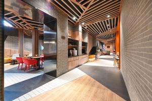 a kitchen and dining room with a brick wall at Beijing Nanluoguxiang Orange Crystal Hotel in Beijing