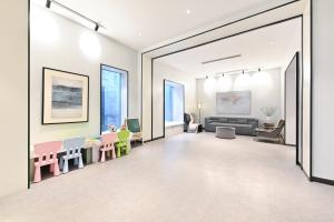 a living room with a table and chairs at Beijing Nanluoguxiang Orange Crystal Hotel in Beijing