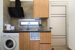 a small kitchen with a sink and a washing machine at Central Cosy Comfort Suite in Nicosia +3 photos