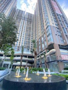 a fountain in front of a large building at 2 bedrooms apartment with free swimming pool, BBQ in Dĩ An +8 photos