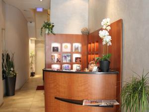 a hotel lobby with a reception desk and plants at Callas am Dom in Cologne