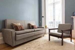a living room with a couch and a chair at bnapartments Carregal in Porto