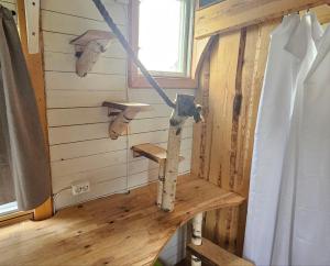 a room in a tiny house with a swing at TinyHouse on eco farm surrounded by nature - Bjorngarden in Sunne