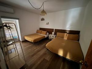 a bedroom with two beds and a couch in it at CASERIO LA SEVILLANA in Baeza