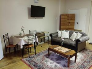 a living room with a couch and a table at Uitenhage Apartments in Uitenhage
