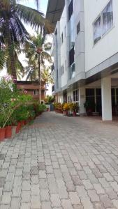 a courtyard of a building with trees and plants at Indeevaram Residency in Trivandrum