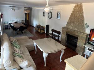 a living room with a couch and a fireplace at CASERIO LA SEVILLANA in Baeza