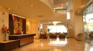 a lobby of a hotel with a reception desk at Lancaster Hotel Manila in Manila +115 photos