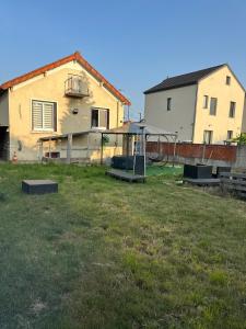 a yard with a playground in front of a house at Maison 1 chambre Jacuzzi Privé in Savigny-sur-Orge