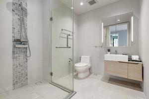 a bathroom with a shower and a toilet and a sink at Diamond Condo apart near Bangtao beach in Bang Tao Beach +10 photos