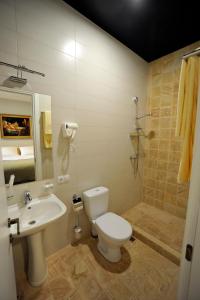 a bathroom with a toilet, sink, and shower at ZP Hotel in Tbilisi City