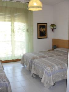 a bedroom with two beds and a window at Al Caminetto in Aosta