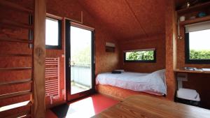 a bedroom with a bed and windows in a house at eco lodges of Mont Bernanchon in Mont-Bernenchon