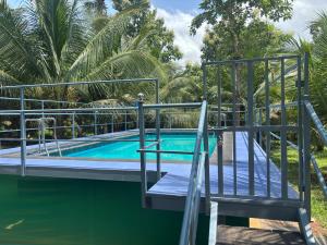 an image of a swimming pool with a slide at Greene Villa in Palakkad