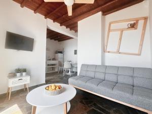 a living room with a couch and a table at Andros memories in Batsi