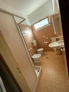 a bathroom with a toilet and a sink at Home 132A in Gatteo a Mare