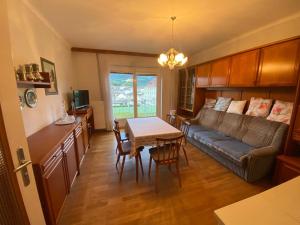 a living room with a couch and a table at Wohnen auf der Sonnenseite in Gloggnitz