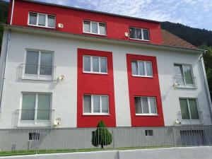 a red and white building with a red at Wohnen auf der Sonnenseite in Gloggnitz