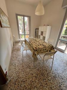 a dining room with a table and two chairs at Residenza tra i Pini in Marina di Grosseto