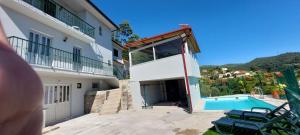 a house with a swimming pool and a building at Casa do Vale in Arcos de Valdevez