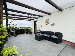 a patio with a couch and a table at Haus-Elena-Wohnung-7B in Bestwig