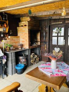 a kitchen with a table and a brick oven at Haus-Elena-Wohnung-7B in Bestwig