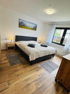 a bedroom with a bed and a large window at Haus-Elena-Wohnung-7B in Bestwig