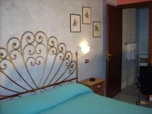 un letto con testiera metallica in una camera da letto di Marta a Trieste