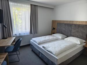 Łóżko lub łóżka w pokoju w obiekcie Hotel Anker