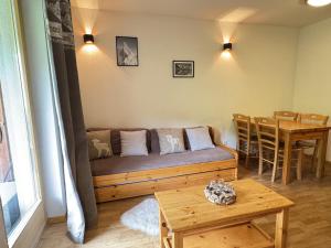 a living room with a couch and a table at Pracondu 2 207 - OUTDOOR & FUN apartment 4 pers in Nendaz