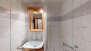a white bathroom with a sink and a mirror at Pracondu 2 207 - OUTDOOR & FUN apartment 4 pers in Nendaz +5 photos