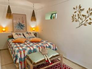 a bedroom with a bed with orange pillows at Lalla Rose in Lalla Takerkoust
