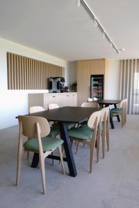 a dining room with tables and chairs and a kitchen at B&B Abdeshof in Middelkerke